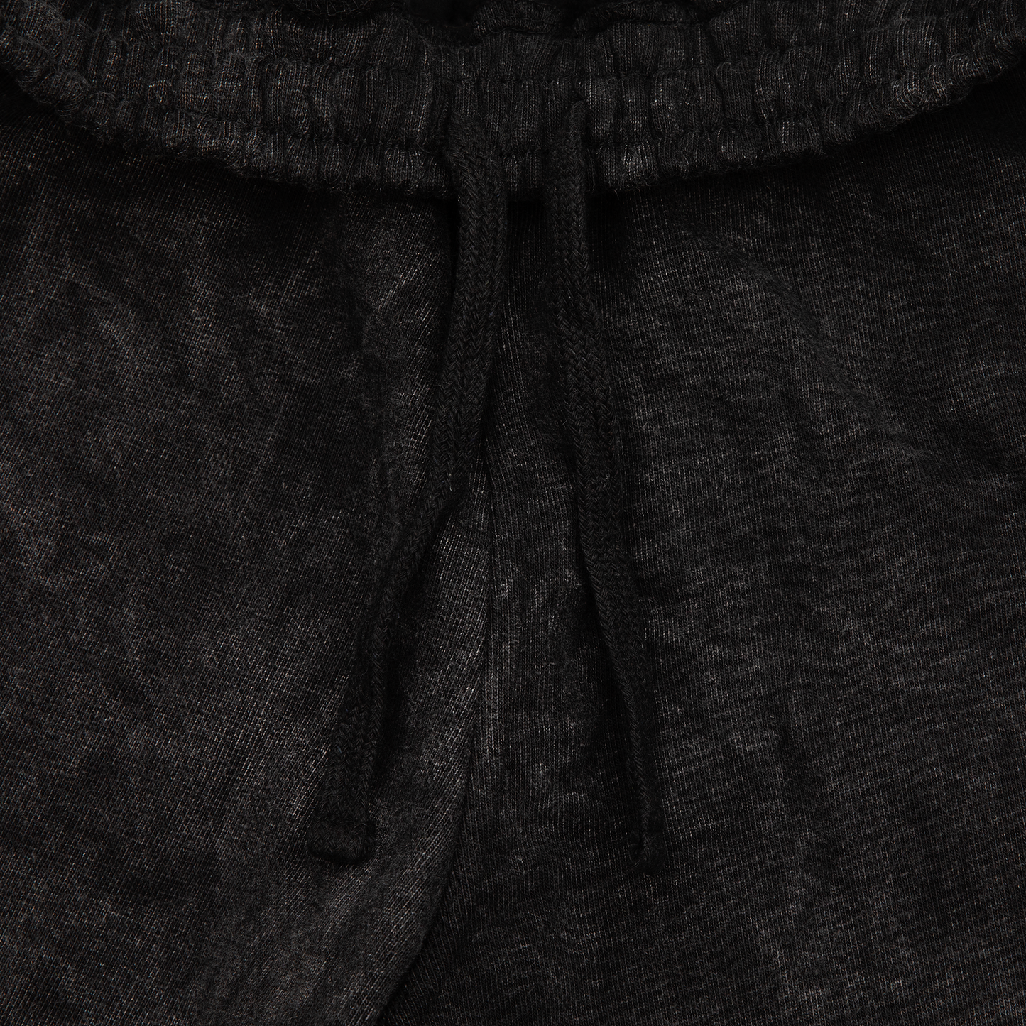 Close up drawstrings view of a acid wash elevated silhouette sweatshorts features refined embroidery and screen-printed details on the front, delivering comfort, structure, and edge in equal measure.