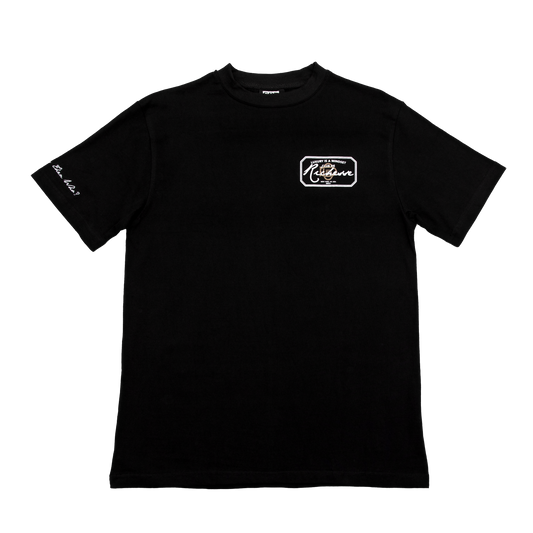 Front  view of a black tee with refined embroidery detail on the sleeve and screen-printed details on the front and back, this tee delivers a balance of comfort, structure, and everyday wearability.