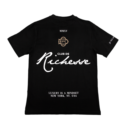 Back view of a black tee with refined embroidery detail on the sleeve and screen-printed details on the front and back, this tee delivers a balance of comfort, structure, and everyday wearability.