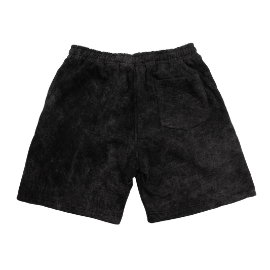Back view of a acid wash elevated silhouette sweatshorts features refined embroidery and screen-printed details on the front, delivering comfort, structure, and edge in equal measure.