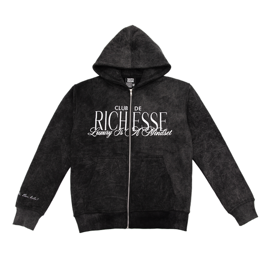Front view of an acid wash full-zip silhouette features elevated embroidery and screen-printed details on the front, balancing structure, comfort, and edge.