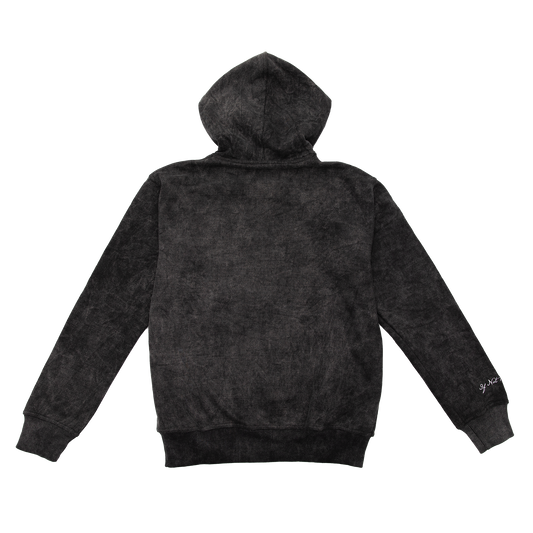 Back view of an acid wash full-zip silhouette features elevated embroidery and screen-printed details on the front, balancing structure, comfort, and edge.