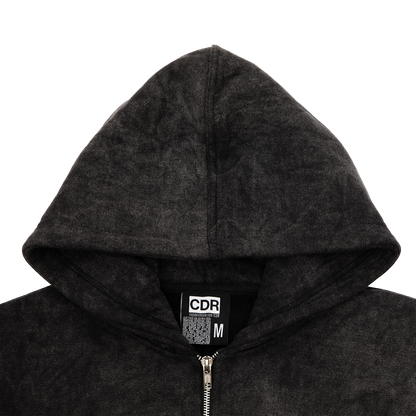 Hood close up view of an acid wash full-zip silhouette features elevated embroidery and screen-printed details on the front, balancing structure, comfort, and edge.