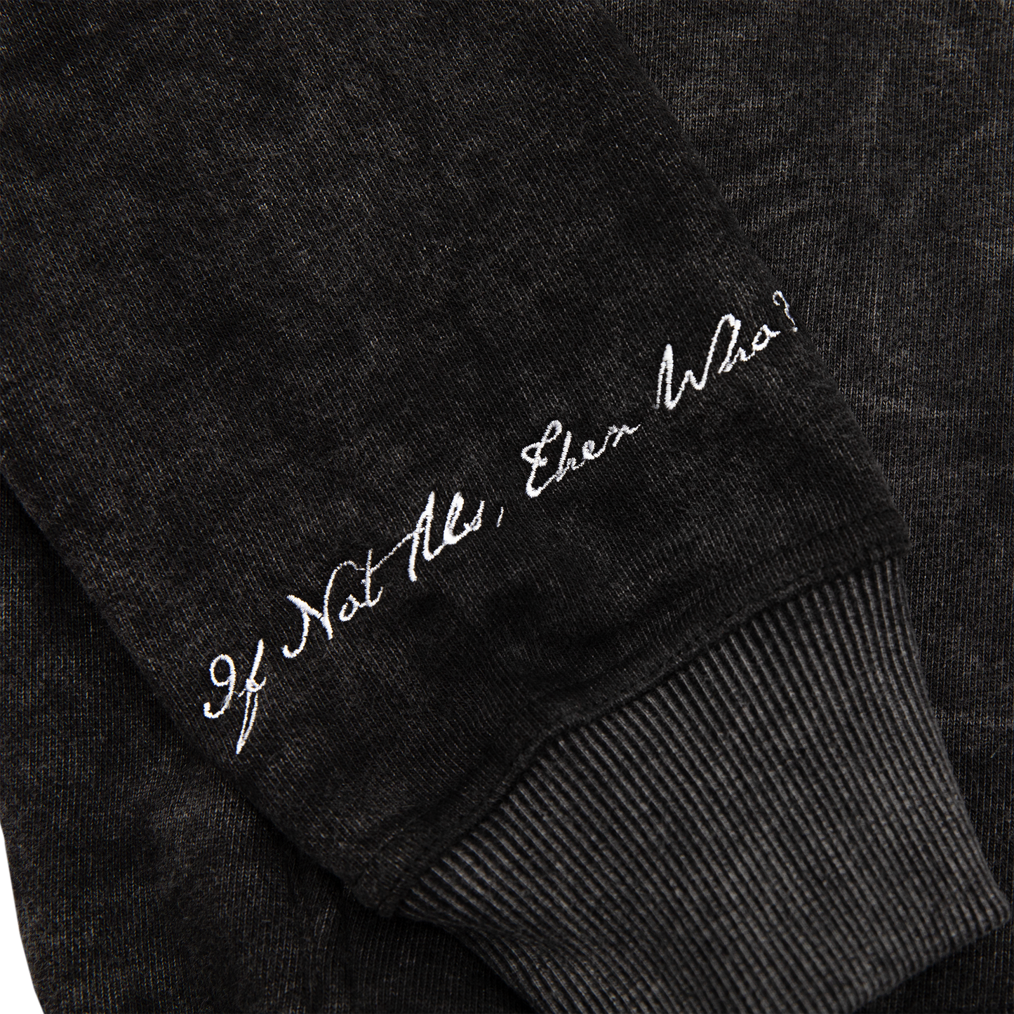 Sleeve close up view of an acid wash full-zip silhouette features elevated embroidery and screen-printed details on the front, balancing structure, comfort, and edge.