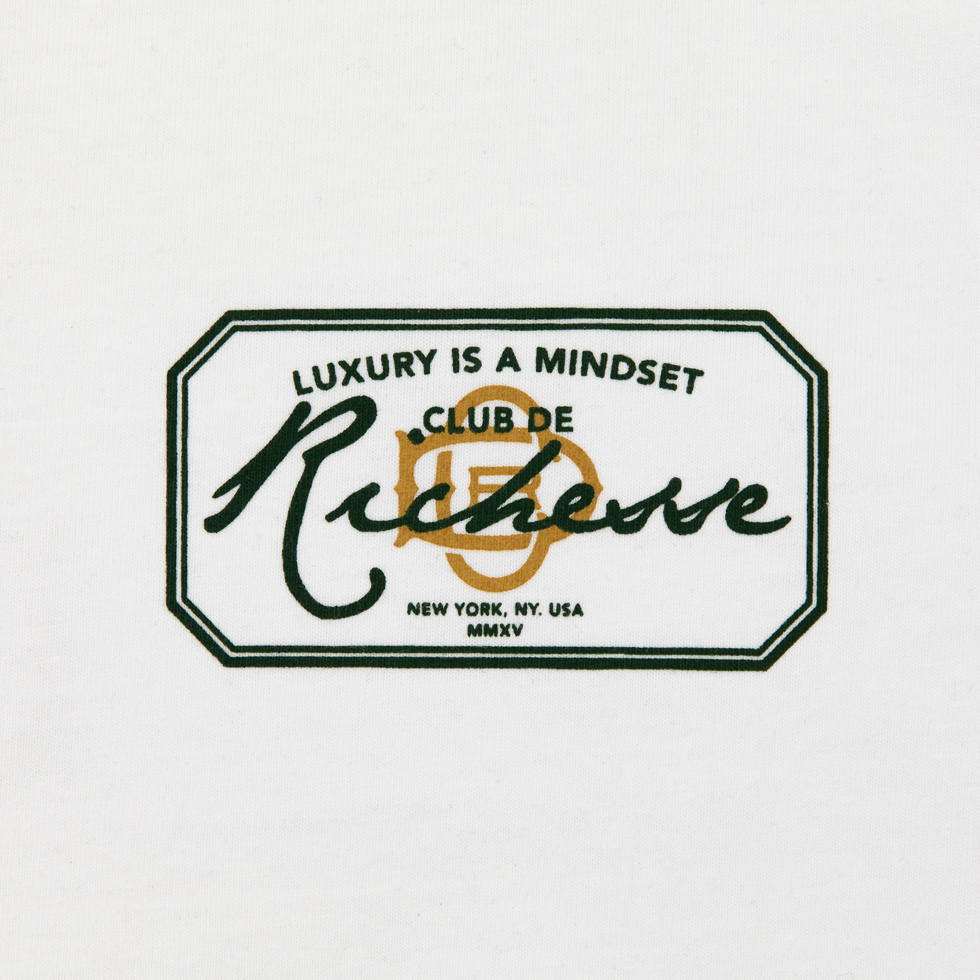 Chest close up  view of a white tee with refined embroidery detail on the sleeve and screen-printed details on the front and back, this tee delivers a balance of comfort, structure, and everyday wearability.