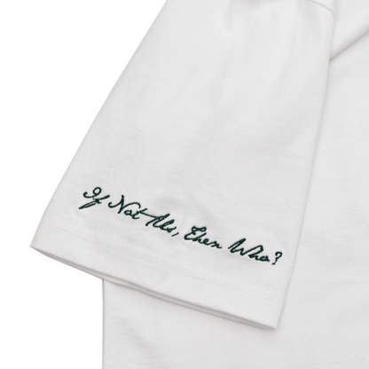 Close up view of a white tee with refined embroidery detail on the sleeve and screen-printed details on the front and back, this tee delivers a balance of comfort, structure, and everyday wearability.
